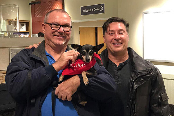 Fudge with his adopter and his foster, Mark Lukas